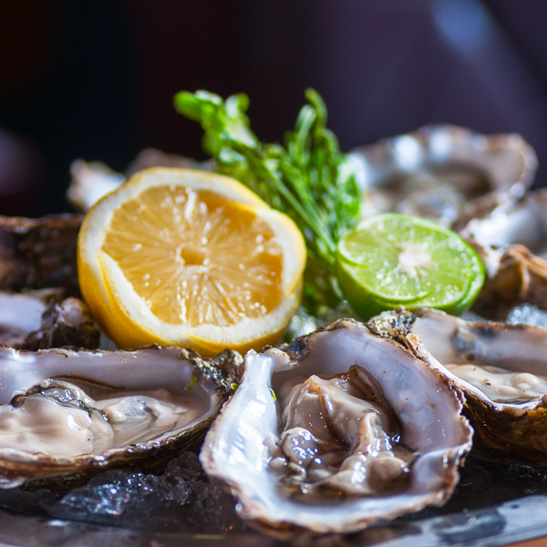 Fresh oyster in
                            dish with lemon and lime By Suporn
                            Thawornnithi_Shutterstock.com