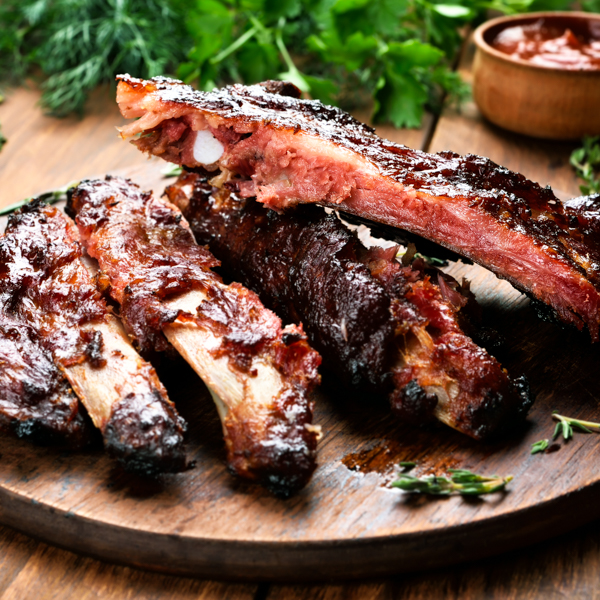 Roasted sliced
                            barbecue pork ribs, focus on sliced meat By Tatiana
                            Volgutova_Shutterstock.com