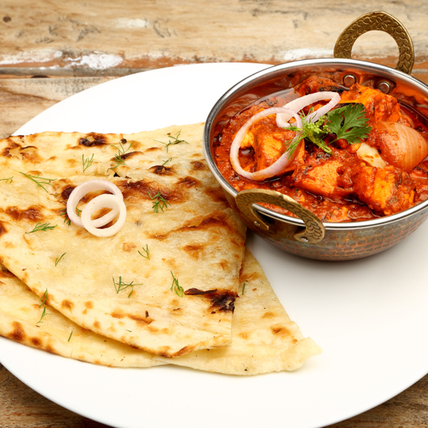Indian Food or
                            Indian Curry in a copper brass serving bowl with
                            bread or roti_KRK Imaging Services_shutterstock.com